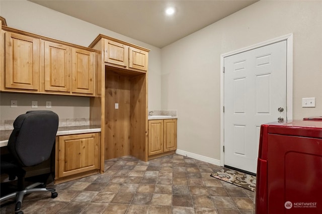 home office with washer / dryer and sink