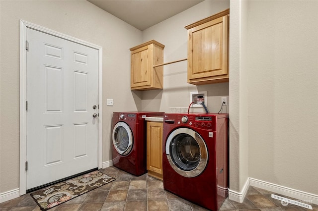 laundry area with cabinets and washing machine and clothes dryer