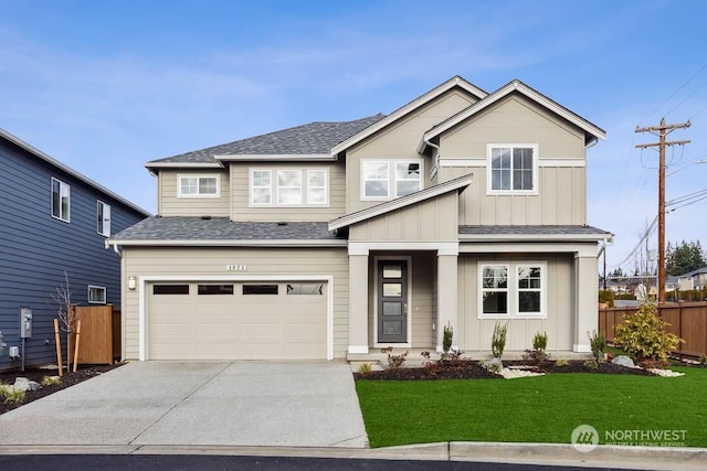 view of front of home with a front yard and a garage