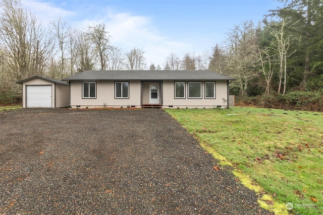 ranch-style home featuring an outbuilding, a front lawn, and a garage