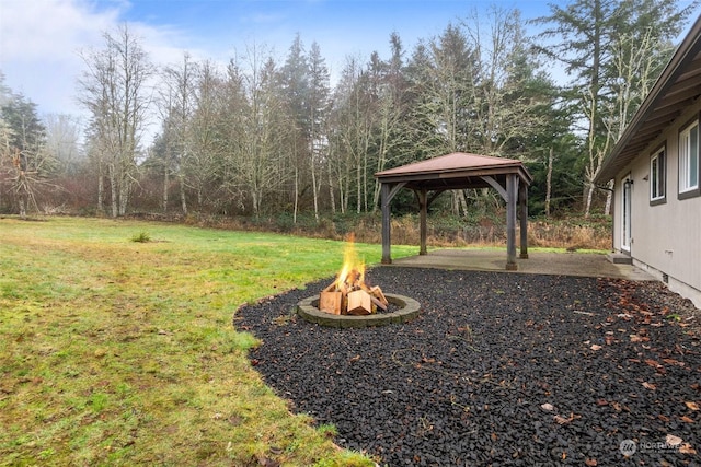 view of yard with an outdoor fire pit, a gazebo, and a patio area