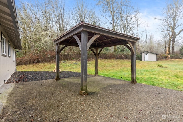 view of yard featuring a patio area, a gazebo, and a storage shed