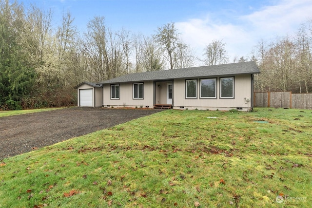 ranch-style house with a garage and a front lawn