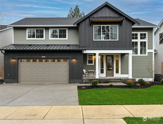 view of front of property with a garage, a porch, and a front lawn