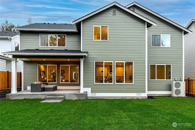 back of property with ac unit, a patio area, a lawn, and an outdoor living space