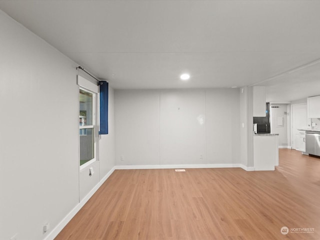 spare room featuring light hardwood / wood-style floors