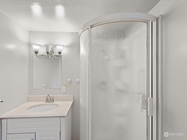 bathroom featuring an enclosed shower and vanity