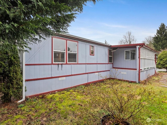 view of side of home featuring a yard