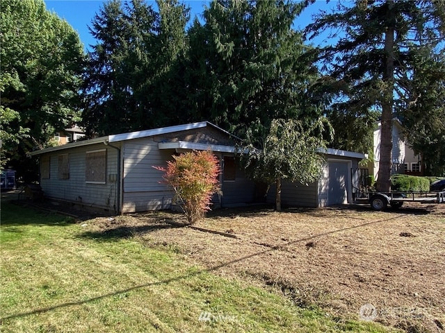 view of side of home featuring a lawn