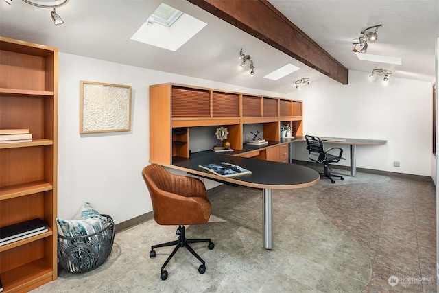 home office with lofted ceiling with skylight