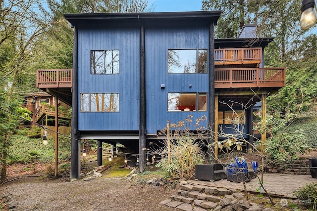 back of property featuring a balcony