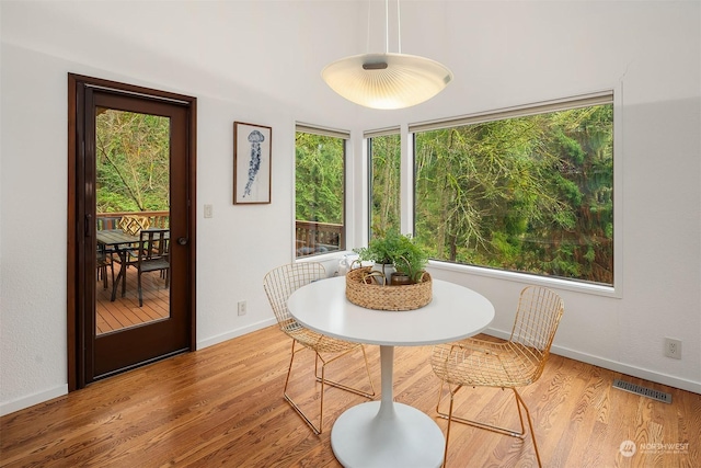 dining space with light hardwood / wood-style flooring