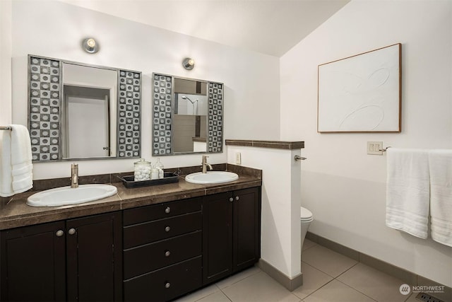 bathroom with lofted ceiling, vanity, tile patterned flooring, and toilet