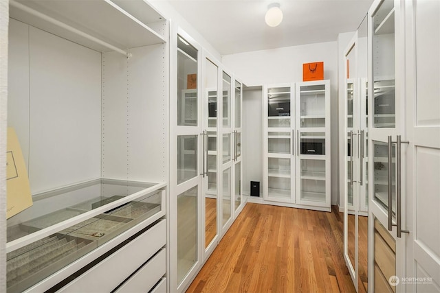 spacious closet with light hardwood / wood-style floors