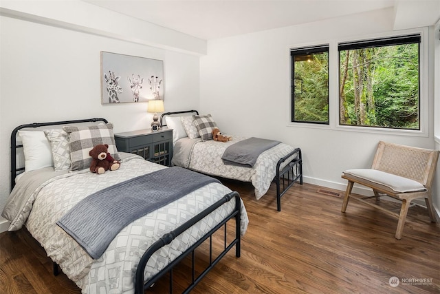 bedroom with dark hardwood / wood-style flooring