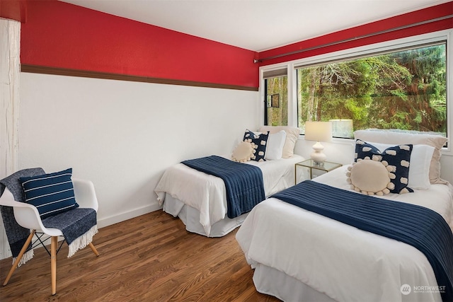 bedroom with dark wood-type flooring