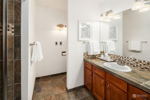 bathroom featuring vanity and decorative backsplash