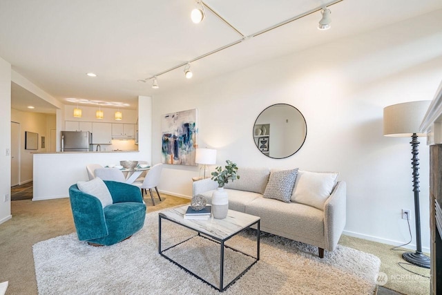 carpeted living room with rail lighting