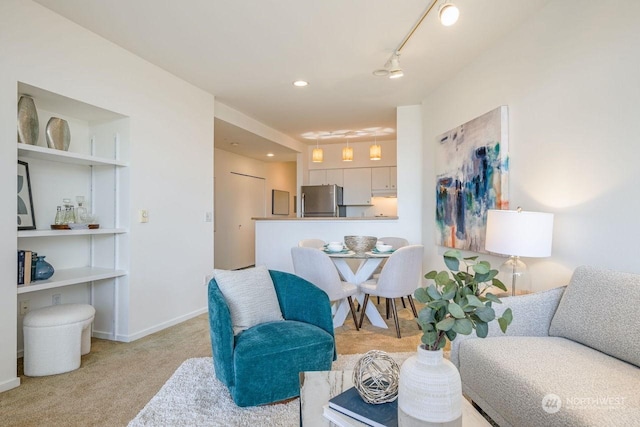 living room featuring light colored carpet and rail lighting