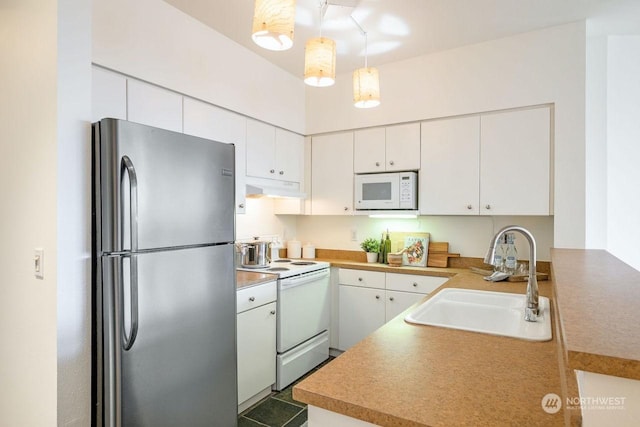 kitchen featuring sink, white cabinetry, white appliances, kitchen peninsula, and hanging light fixtures