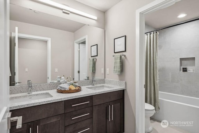 full bathroom featuring toilet, shower / tub combo with curtain, and vanity