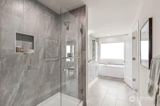 bathroom featuring separate shower and tub, vanity, and tile patterned floors