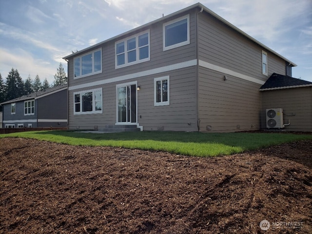 rear view of property with a lawn and ac unit