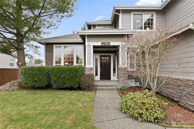 entrance to property with a lawn