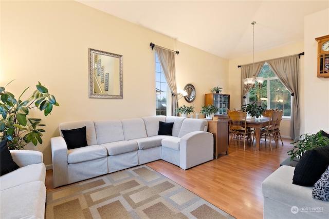 living room with wood-type flooring and a chandelier