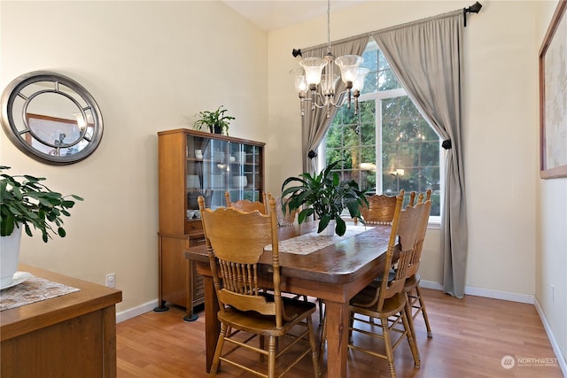 dining space with a chandelier and light wood-type flooring