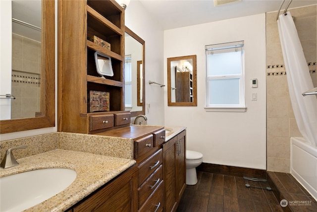 full bathroom featuring vanity, shower / bath combo with shower curtain, and toilet