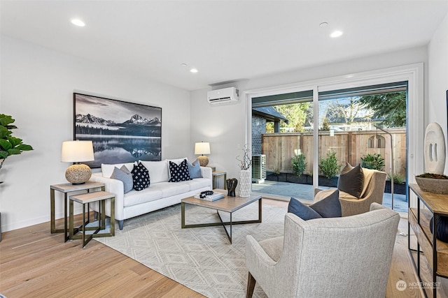 living room with light wood-type flooring and a wall unit AC