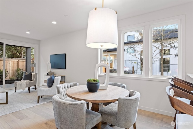 dining space with light hardwood / wood-style floors