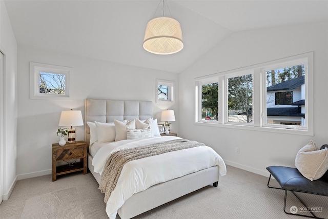 bedroom featuring light colored carpet and vaulted ceiling