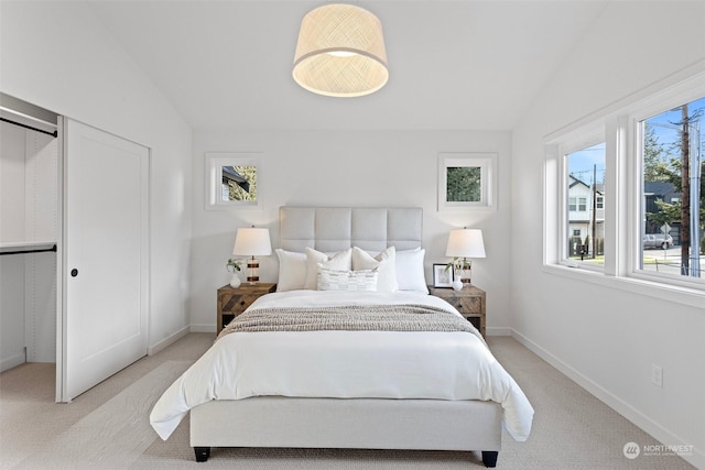 carpeted bedroom with vaulted ceiling