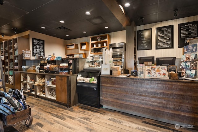 bar with hardwood / wood-style flooring