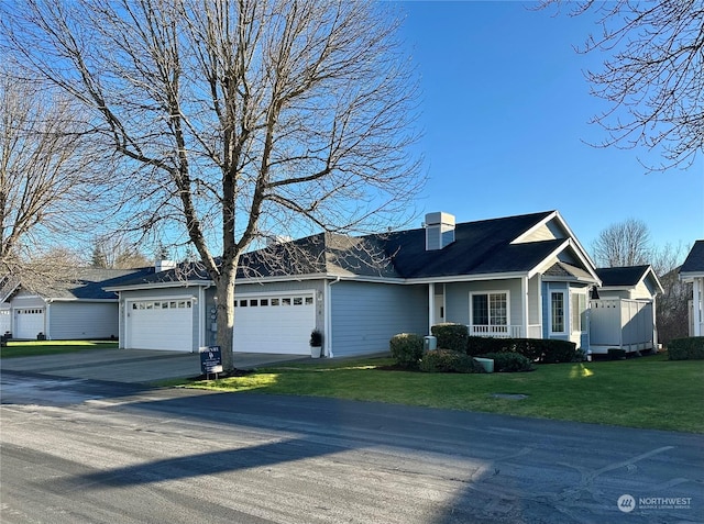 view of front of house featuring a front yard and a garage