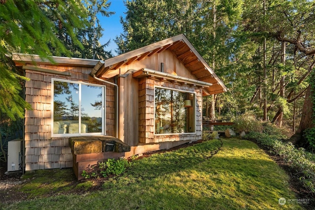 view of outbuilding featuring a lawn