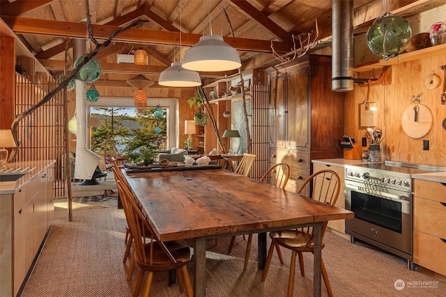 carpeted dining room with lofted ceiling with beams, wooden walls, and wood ceiling