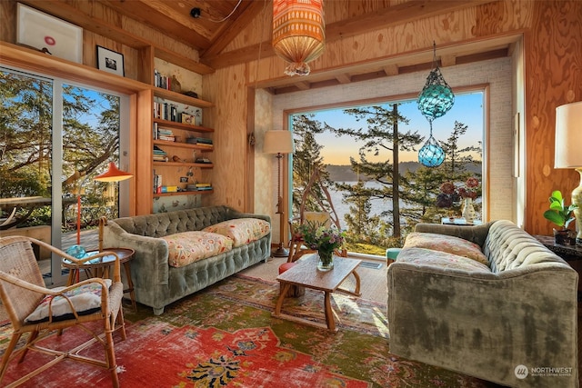 living area with built in shelves, wooden walls, lofted ceiling, and wood ceiling