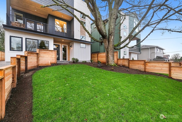 back of property featuring a lawn and a balcony