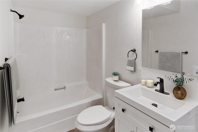 bathroom with shower / tub combination, vanity, and toilet