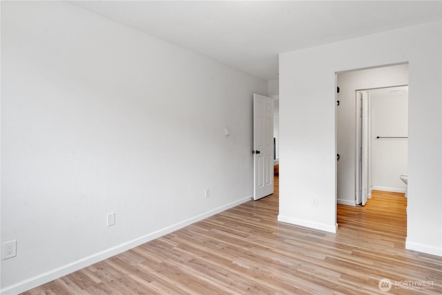 unfurnished bedroom featuring light wood-type flooring and baseboards