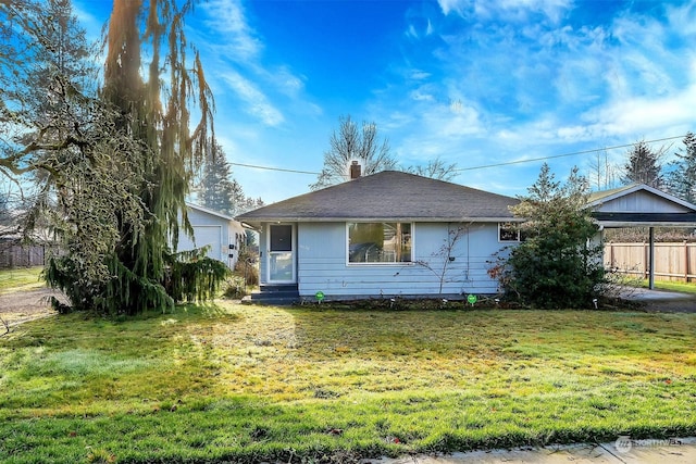 rear view of house with a yard