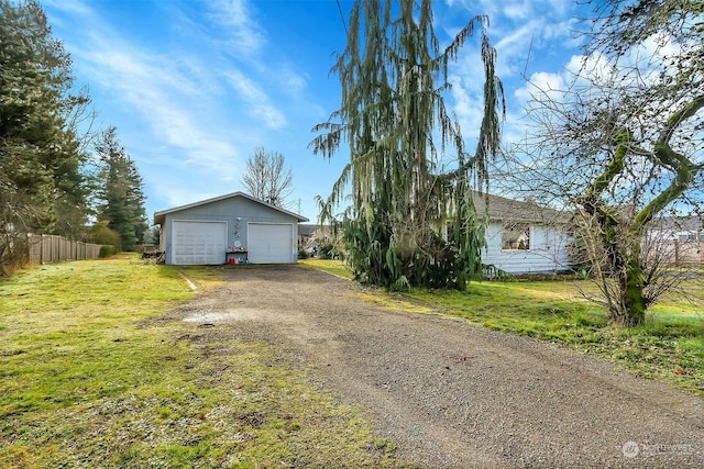 exterior space featuring an outbuilding, a garage, and a yard