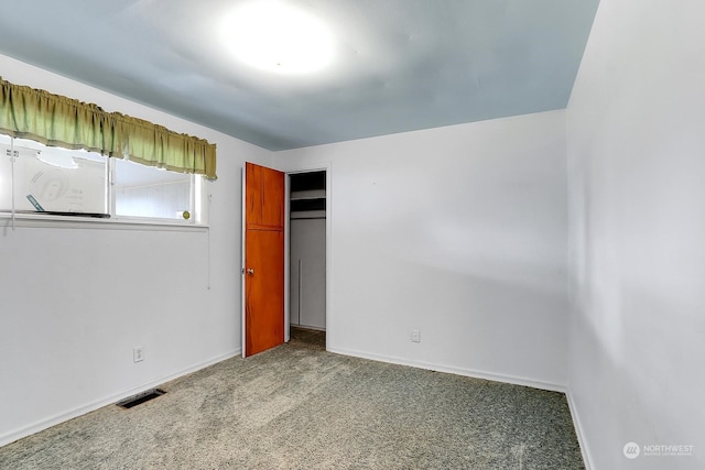 unfurnished bedroom with a closet and carpet flooring