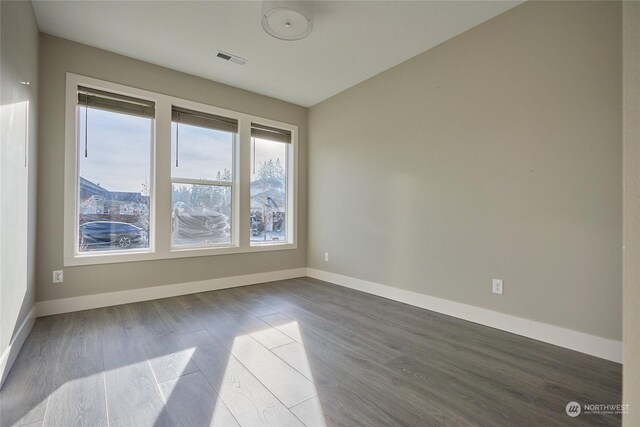 empty room with wood-type flooring