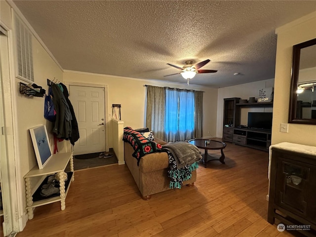 living room with wood-type flooring, a textured ceiling, and ceiling fan