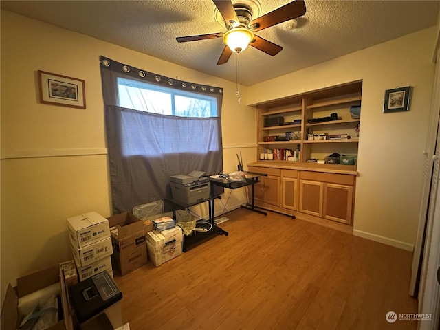 misc room featuring a textured ceiling, ceiling fan, and hardwood / wood-style floors