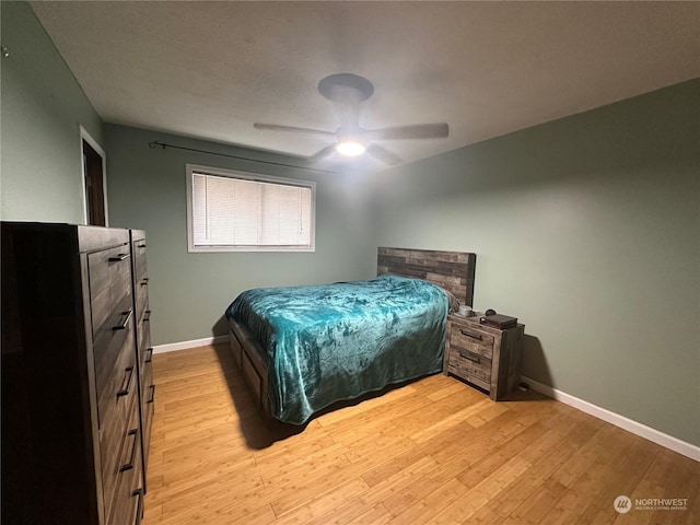 bedroom with ceiling fan and light hardwood / wood-style floors